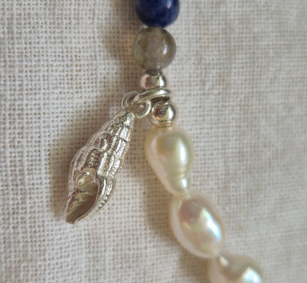 Spiral shell charm on a gemstone and keish pearl bracelet