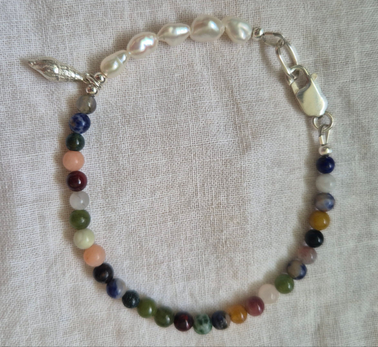 Spiral shell charm on a gemstone and keish pearl bracelet